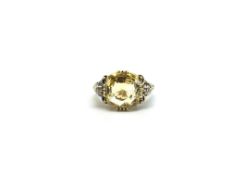 A Yellow Sapphire Ring. The 14.42ct sapphire (14.10 x 11.29 x 8.77 mm) complete with certificate