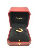 Cartier Ellipse ruby crossover ring mounted in 18ct yellow gold, each terminal set with an oval