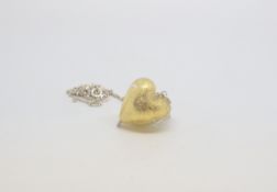 A silver chain with a Glass yellow in colour in a heart shape pendant, marked as silver, approx