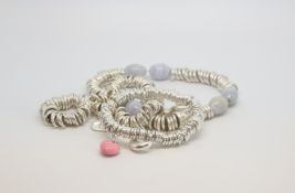 A selection of silver Links or London bracelets and charms, marked and tested as silver Approx gross
