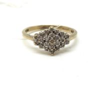 A diamond cluster ring. Ring size N, Approximately 2.1g gross. Fully hallmarked for 9ct gold.