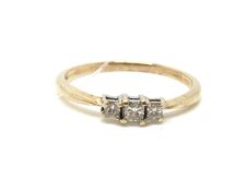 Three Stone Diamond Ring. Gold mount. Hallmarked for 9ct gold. Size T. Approximately 1.7g gross.