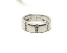 Diamond set band, Total diamond weight 0.15ct. Approximately 3.9g gross. Ring size J 1/2. Fully