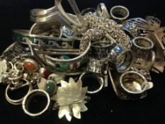 A selection of Mexican silver jewellery including rings,bangles and pendants, some set with semi