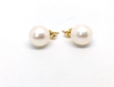 Single 9.8mm pearl ear studs, set in yellow metal stamped 18ct