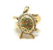 Emerald set turtle ring, articulated turtle with stone set shell, gem set eyes, in yellow metal