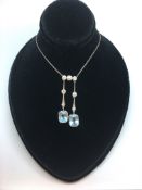 Aquamarine and diamond double drop pendant, two matching rectangular cut aquamarines, suspended from