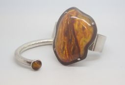 Two lovely Bangles, One of a large amber coloured stone and the other of Tiger eyes set tourque