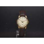 A Gentlemans 1950s 9ct Gold Smith Deluxe watch. The watch has a two tone dial with gold hands and