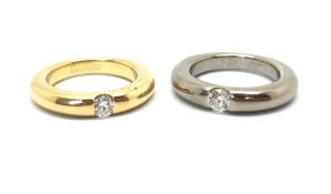 Cartier - a pair of Elipse diamond set bands, estimated diamond weight 0.25ct each, one in yellow