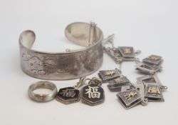 A selection of far eastern deisgned and fancy engraved jewellery items, marked and tested as silver,