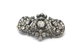 Old cut diamond brooch, old and rose cut diamonds set acrosss and intricate silver and gold setting,