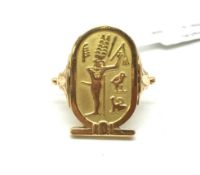 Egyptian panel ring, hieroglyphics to panel, detailed shoulders, ring size O, in yellow metal tested