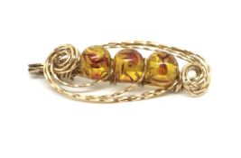 Amber set brooch, in yellow metal tested as approximately 14ct, approximately 7.7g gross