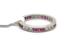 Art Deco style ruby and diamond eternity ring, sets of three round brilliant cut diamonds and