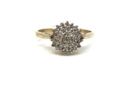 A diamond cluster ring. Ring size N, Approximately 2.0g gross. Fully hallmarked for 9ct gold. 0.25ct