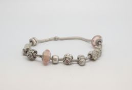 A Pandora Bracelet with charms, marked and tested as silver, approx gross weight 48.0gr