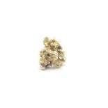 An 18ct yellow gold ring set with a nugget of 14ct gold. Total weight 22.51g