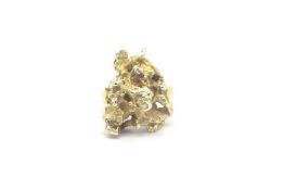 An 18ct yellow gold ring set with a nugget of 14ct gold. Total weight 22.51g