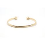 A 9ct yellow gold bangle. Approximately 15.86g