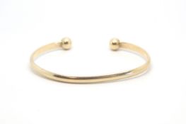 A 9ct yellow gold bangle. Approximately 15.86g