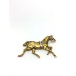 Horse brooch, yellow metal with intricate detail, and white metal reigns, stamped 14ct, measures