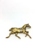 Horse brooch, yellow metal with intricate detail, and white metal reigns, stamped 14ct, measures