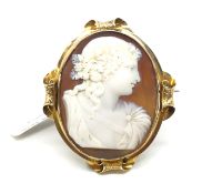 Shell cameo brooch in yellow metal frame, depicting a maiden with a floral headpiece. Yellow metal