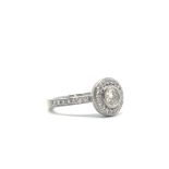 18ct Diamond Halo Ring. The central brilliant cut diamond surrounded by a halo of diamonds with