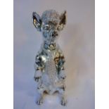 Silver coloured anthropomorphic chihuahua figure in a begging pose