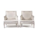 A pair of late 19th/early 20th century white painted fauteuils, in the Louis XVI style.