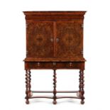 A William & Mary olivewood oyster veneered and crossbanded cabinet on stand.