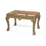 A George I style green japanned, carved giltwood and composition stool.
