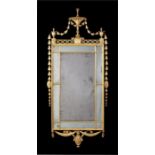 A George III carved giltwood marginal wall mirror, in the Adam style.
