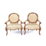A pair of Victorian birds-eye maple carved fauteuils, in the Louis XV style.