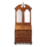 A fine George I walnut, crossbanded and featherbanded bureau bookcase in the manner of Coxed &