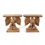 A pair of George II style Kentian carved gilt wood eagle consoles.