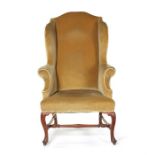 A George II walnut wing armchair.