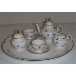 A Miniature Caverswall tea set for two, each piece signed by M. Grant.