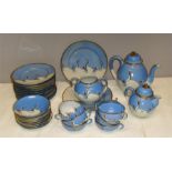 A Japanese porcelain part tea service with blue a ground and painted with cranes.