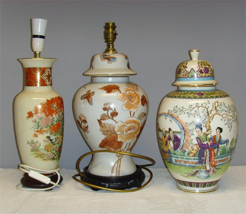 Two Chinese style ceramic lamp bases, together with a Japanese jar and cover depicitng figures to
