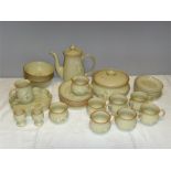 A Denby Pottery part tea/dinner service comprising six cups and saucers, a tea pot, sugar bowl, milk