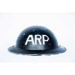 An army helmet, labelled later ARP.
