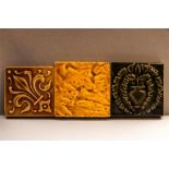 Three antique glazed tiles; two Craven Dunnhill & Co of Shropshire, and one by Lamigeon & Co,