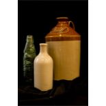 A 19th century stoneglazed jar; W.T Duckett of Stamford, a green glass bottle, Headley Late Elsie,