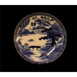 A 19th century blue and white Chinese charger depicting a landscape with decorative border, 46cm