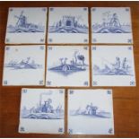 A set of eight 19th century blue and white Delft tiles depicting various traditional buildings in