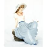 A Nao Lladro figure, reclining lady.