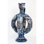 A late 19th century German cobalt blue salt-glazed relief stoneware double ring ewer, the neck