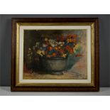 An oil on canvas, 20th century, still life of flowers in a bowl, indistinctly signed.